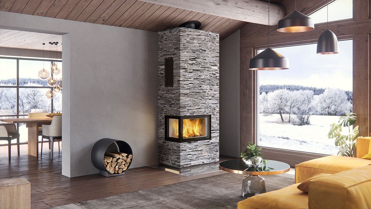 Moderne peis i stein med peisinnsats på moderne hytte.